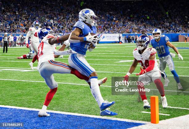 Kenny Golladay of the Detroit Lions makes the touchdown catch as Deandre Baker and Grant Haley of the New York Giants defend during the third quarter...