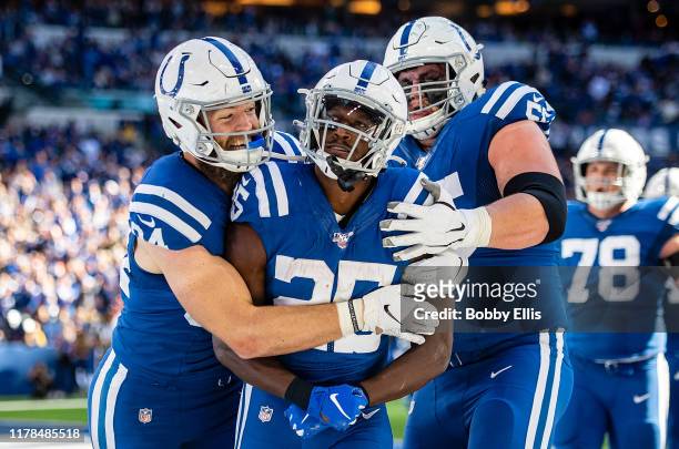 Jack Doyle, Marlon Mack and Quenton Nelson of the Indianapolis Colts celebrate after Mack ran for a touchdown in the third quarter of the game...
