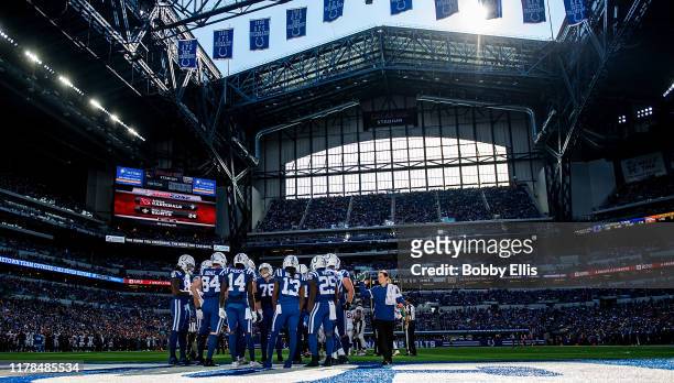 The Indianapolis Colts offense huddles up before a play in the third quarter of the game against the Denver Broncos at Lucas Oil Stadium on October...