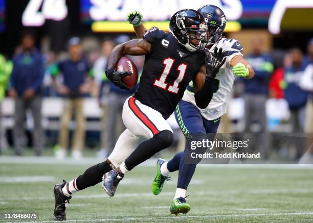 Julio Jones of the Atlanta Falcons is tackled by Akeem King of the Seattle Seahawks in the second half of an NFL game at Mercedes-Benz Stadium on...