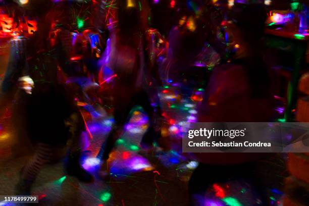 group of friends dancing together from halloween party. - disco costume stockfoto's en -beelden