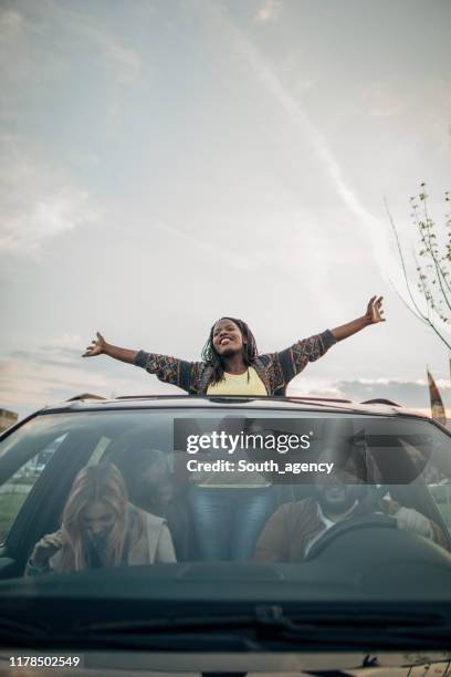 black woman enjoying in car ride - sunroof stock pictures, royalty-free photos & images