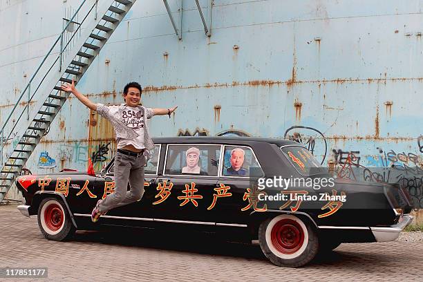 Man jumps at the show car in the 798 Art Exhibition Commemorating CPC'S 90th Anniversary on July 1, 2011 in Beijing, China. This year's celebrations...