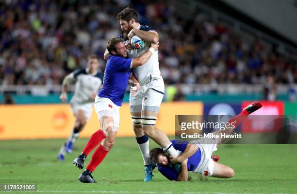 Greg Peterson of the United States is tackled by Camille Lopez and Sebastien Vahaamahina of France during the Rugby World Cup 2019 Group C game...