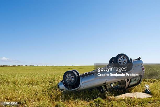 car crashed on country road with field and sky - car accident stock pictures, royalty-free photos & images