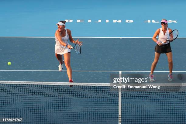 Nicoloe Melichar of USA and Kveta Peschke of Czech Republic return a shot against Julia Goerges of Germany and Anastasija Sevastova of Latvia during...