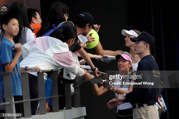 Nicoloe Melichar of USA and Kveta Peschke of Czech Republic sign autograph after winning their Women's doubles match against Julia Goerges of Germany...