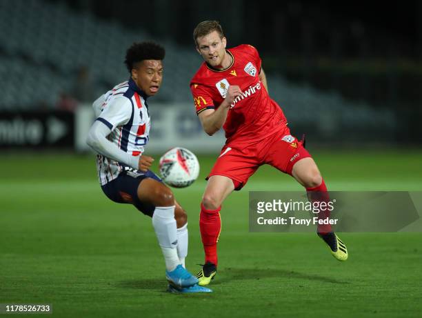 Ryan Kitto of Adelaide United contests the ball with Samuel Silvera of the Central Coast Mariners during the FFA Cup 2019 Semi Final between the...