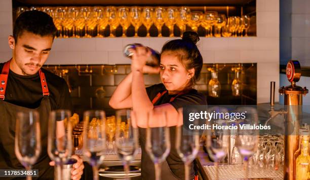 Bartenders prepare cocktails in "O Asiatico", a thematic restaurant favored by locals and tourists who are into Asian flavors in Principe Real...