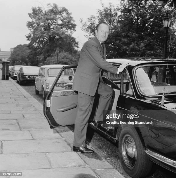 British politician John Peyton, Baron Peyton of Yeovil , the new Minister of Transport, standing next to a car , UK, 2nd July 1970.