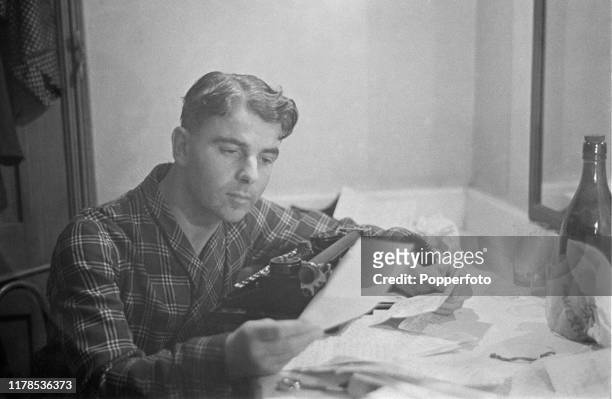 Welsh writer and actor Emlyn Williams reads a letter in his dressing room backstage prior to a performance in Blackpool, England during World War II...
