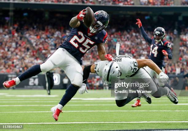 Duke Johnson of the Houston Texans scores a touchdown defended by Erik Harris of the Oakland Raiders in the second quarter at NRG Stadium on October...