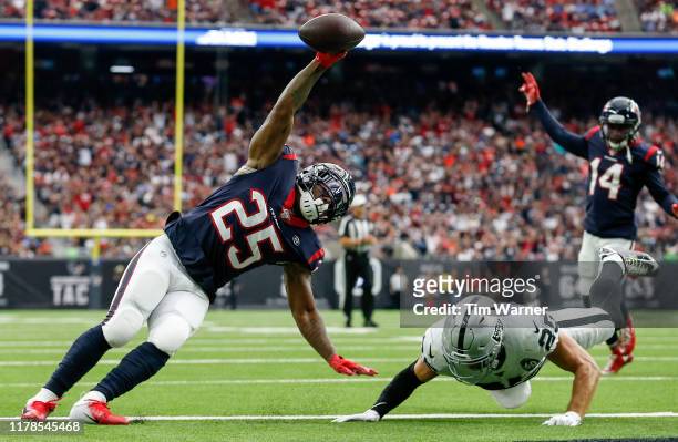 Duke Johnson of the Houston Texans scores a touchdown defended by Erik Harris of the Oakland Raiders in the second quarter at NRG Stadium on October...