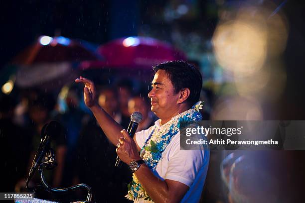 Thai Prime Minister and leader of the Democrat party Abhisit Vejjajiva speaks during a final campaign rally under heavy rain at Royal Plaza on July...