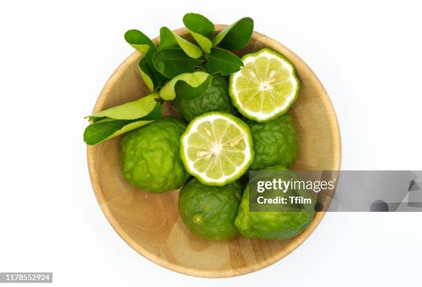 bergamot, citrus hystrix, in a wooden bowl on white background - bergamot stock pictures, royalty-free photos & images