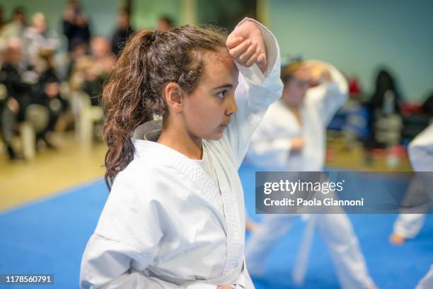 sports and disciplines. martial arts. pre-teen girl during a karate class in gym - judo girl stock pictures, royalty-free photos & images