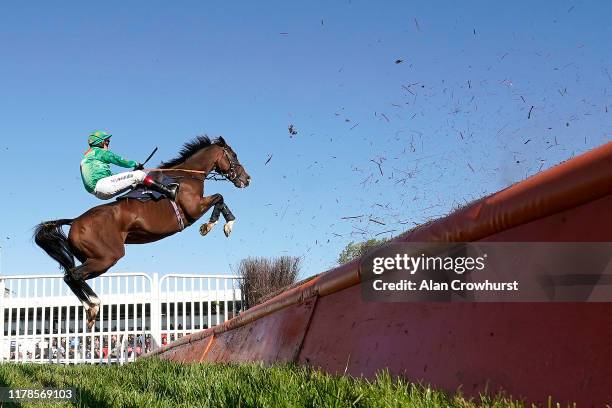 Richard Johnson riding Invincible Don makes a spectacular leap at the open ditch in The Best Odds Guranteed At MansionBet Novices' Handicap Chase...