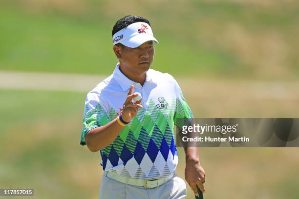 Choi of South Korea waves to the crowd on the eighth hole during the second round of the AT&T National at Aronimink Golf Club on July 1, 2011 in...
