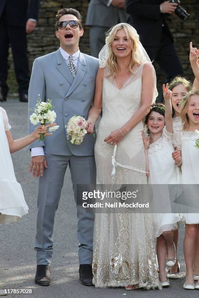 Kate Moss and Jamie Hince pose outside the church after getting married on July 1, 2011 in Southrop, England.