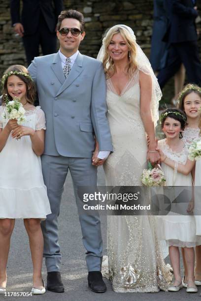 Kate Moss and Jamie Hince pose outside the church after getting married on July 1, 2011 in Southrop, England.