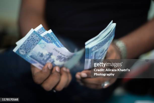 counting money - pakistan currency stock pictures, royalty-free photos & images