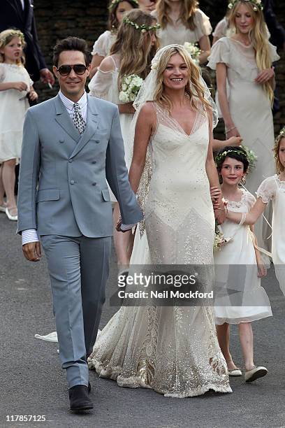 Kate Moss and Jamie Hince walk outside the church after getting married on July 1, 2011 in Southrop, England.