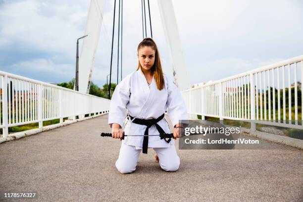 mädchen hält ihr schwert - women's judo stock-fotos und bilder