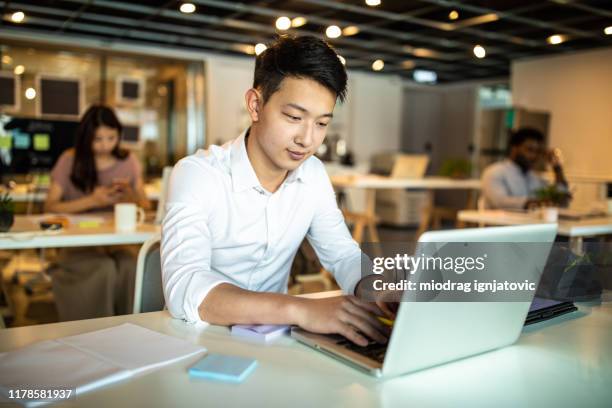 working hard to make it through another successful day - chinese ethnicity stock pictures, royalty-free photos & images