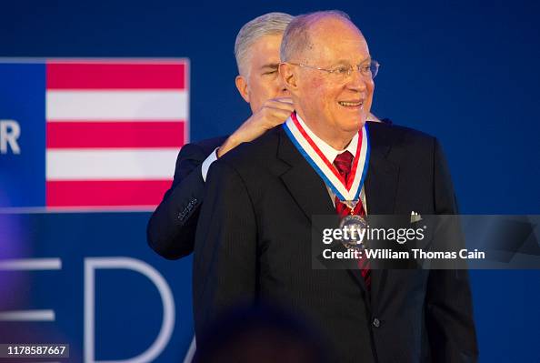 Retired Supreme Court Justice Anthony Kennedy is presented the