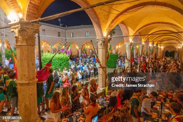 each contrada (neighbourhood), has its own dress rehearsal (prova generale) dinner the night before the palio, a bareback horserace, dating back to the 16th century, held twice each summer in piazza del campo, august 2019, siena, tuscany, italy - prova generale stockfoto's en -beelden