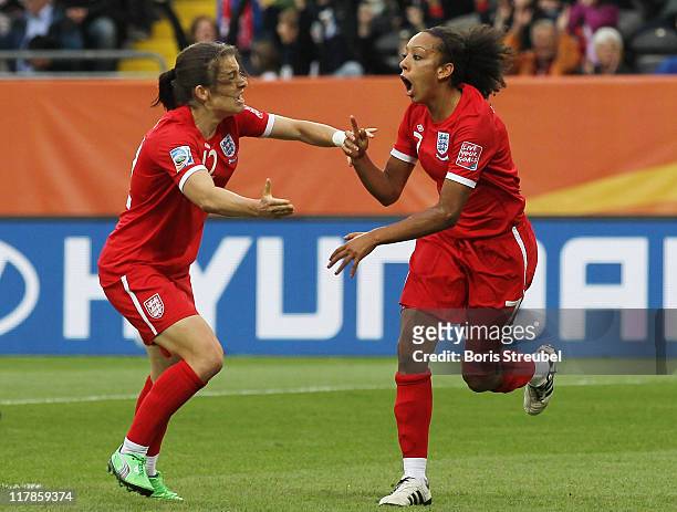 Jessica Clarke of England celebrates after scoring her team's 2nd goal wth her team mate Karen Carney during the FIFA Women's World Cup Group B match...