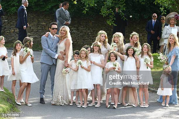 Jamie Hince, Kate Moss and their bridesmaids outside the church after their wedding on July 1, 2011 in Southrop, England.