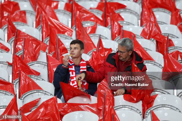 Fans eat refreshments as they take their seats prior to the UEFA Champions League group H match between Lille OSC and Chelsea FC at Stade Pierre...