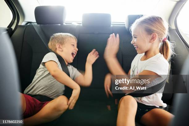 children playing while traveling - kids car stock pictures, royalty-free photos & images