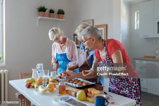 seniors preparing food - international womens day 2019 stock pictures, royalty-free photos & images