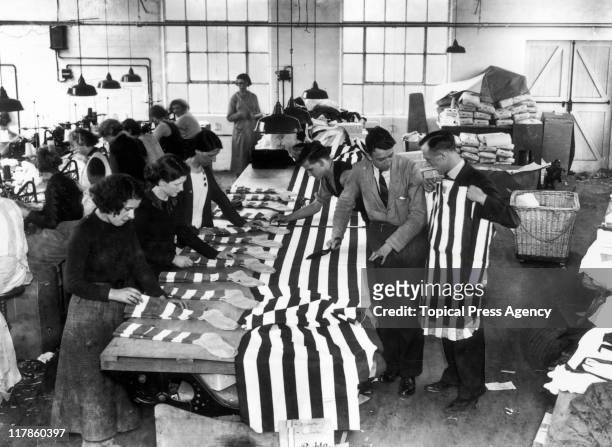 Workers preparing football shirts for Sunderland AFC, and socks for Preston North End FC, at the Bukta factory in Manchester, Lancashire, England,...