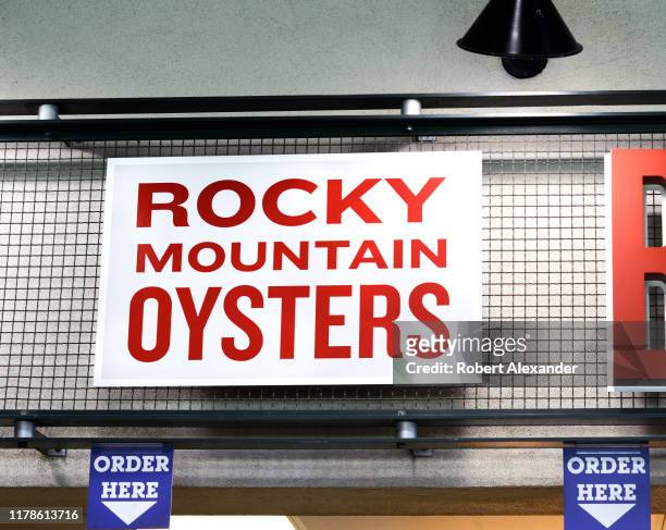 Sign at a food stand in Coors Field advertises its 'Rocky Mountain oysters' which are deep fried bull testicles. Coors Field in Denver, Colorado, is...