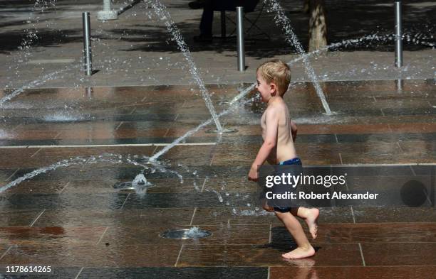 Boy plays in a water park in downtown Denver, Colorado.