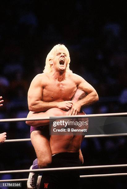 Road Warrior Hawk squeezes the "Nature Boy" Rick Flair during their Heavy Weight bout at the 1988 Bunkhouse Stampede on January 24, 1988 at the...