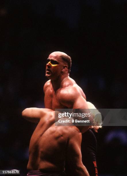 Road Warrior Hawk gets ready to perform the suplex on the "Nature Boy" Rick Flair during their Heavy Weight bout at the 1988 Bunkhouse Stampede on...