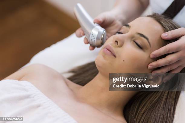 smoothing the skin.beauty salon. - laser face stock pictures, royalty-free photos & images