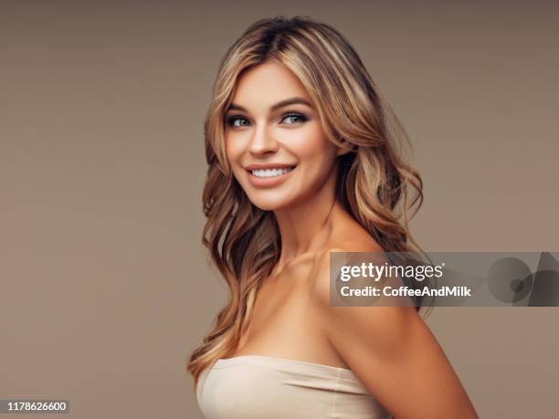 brown haired woman with voluminous hairstyle - big hair stock pictures, royalty-free photos & images