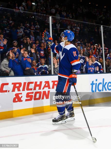 Mathew Barzal of the New York Islanders tosses a puck to the fans after his teams 5-3 win over the Philadelphia Flyers at NYCB Live's Nassau Coliseum...