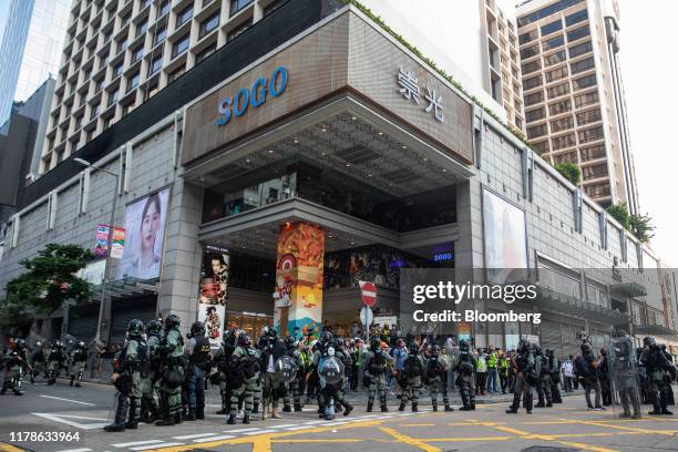 Riot police stand in front of the Sogo department store in the Tsim Sha Tsui district of Hong Kong, China, on Sunday, Oct. 27, 2019. Hong Kong...