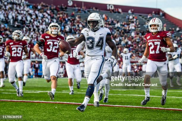 Connecticut running back Kevin Mensah outruns the UMass defense for a 17-yard touchdown in the first quarter at Warren McGuirk Alumni Stadium in...