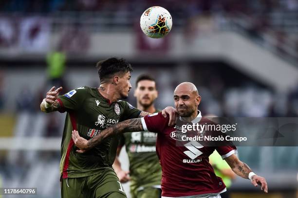 Simone Zaza of Torino FC competes for the ball with Fabio Pisacane of Cagliari Calcio during the Serie A football match between Torino FC and...