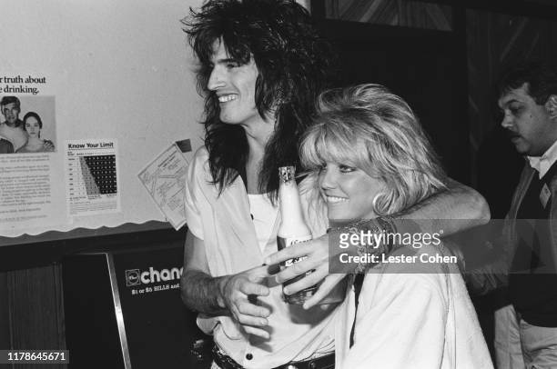Tommy Lee of Mötley Crüe poses for a photo with Heather Locklear circa 1985.