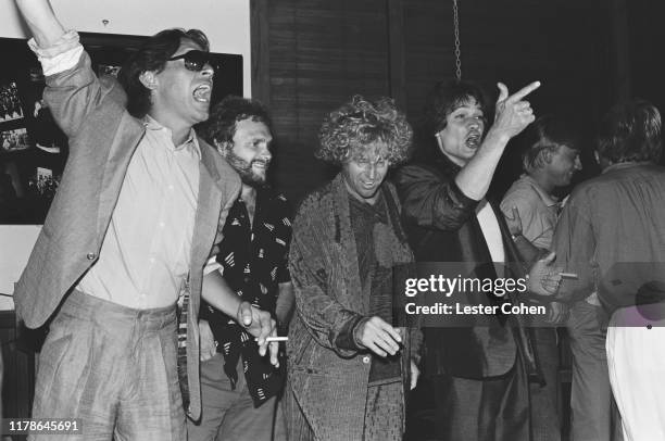 Alex Van Halen, Michael Anthony, David Lee Roth and Sammy Hagar, and Eddie Van Halen of Van Halen pose with platinum record sales plaques for the...