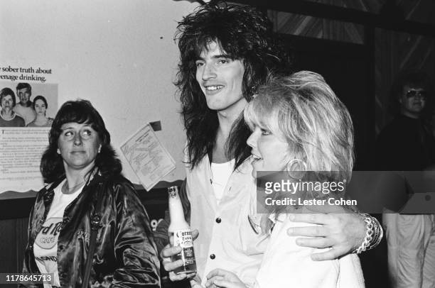 Tommy Lee of Mötley Crüe poses for a photo with Heather Locklear circa 1985.