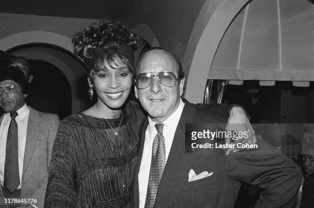 Whitney Houston and Clive Davis attend a party circa 1989.